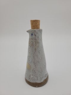 Bottle for oil or vinegar with white glaze floral design.