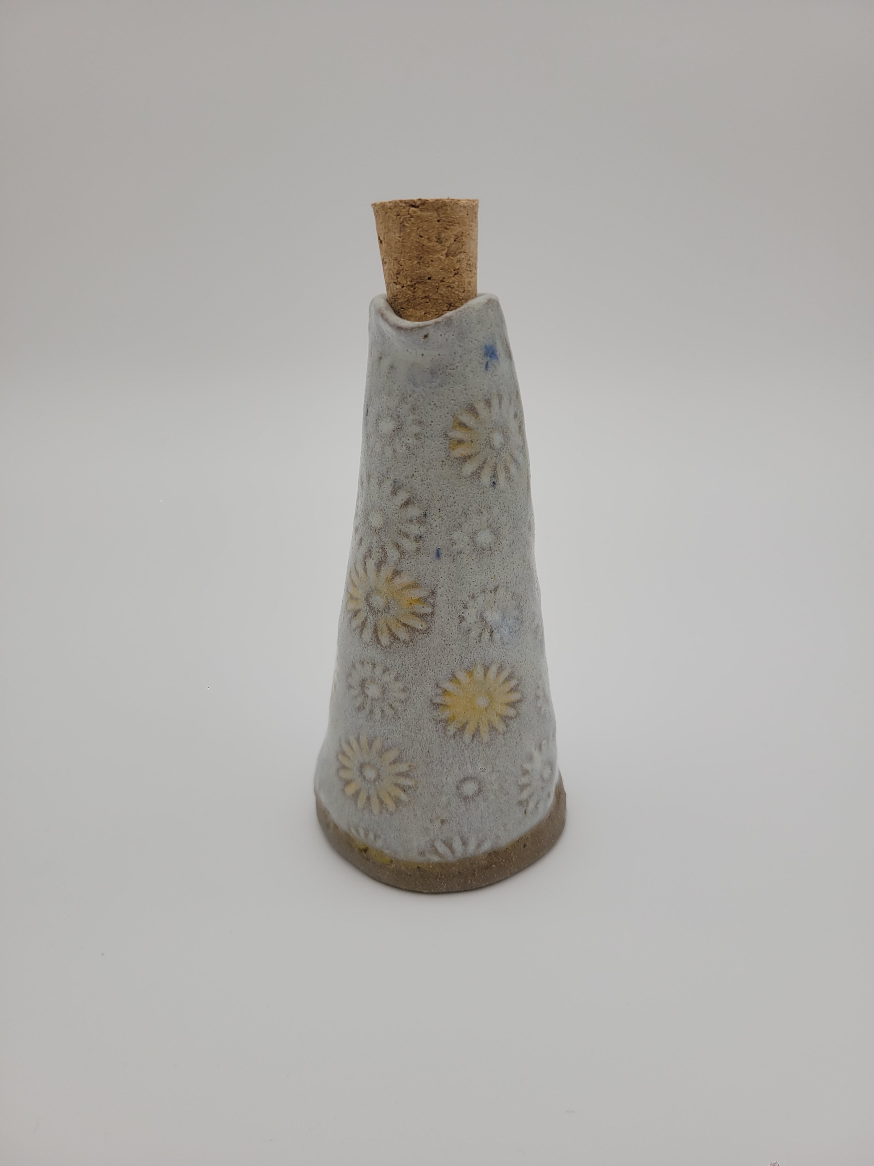 Bottle for oil or vinegar with white glaze floral design.