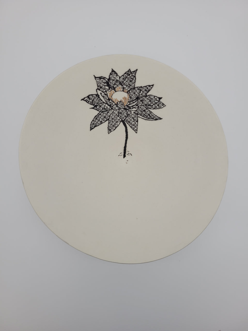 White ceramic bowl with black floral detail