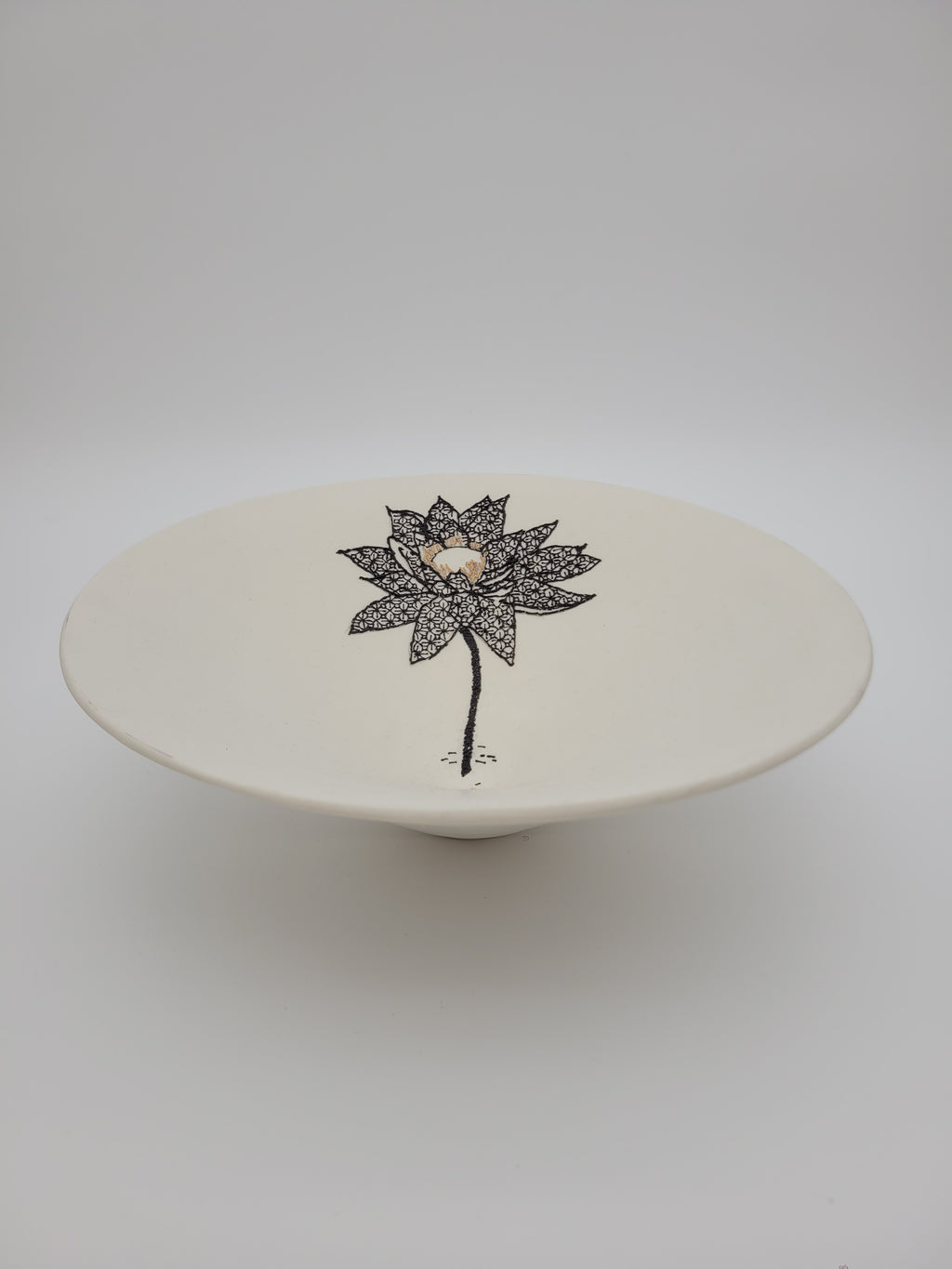 White ceramic bowl with black floral detail