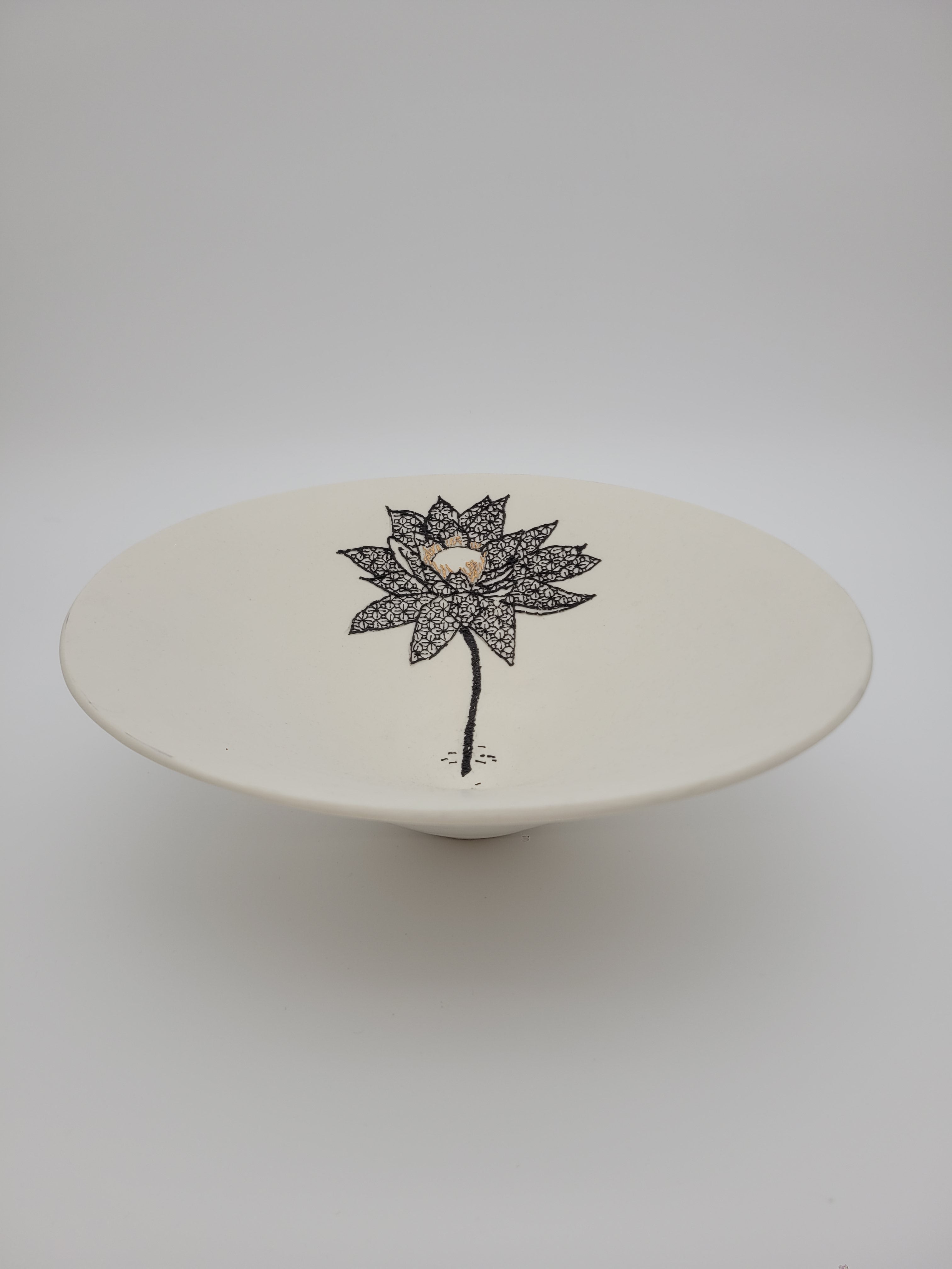 White ceramic bowl with black floral detail