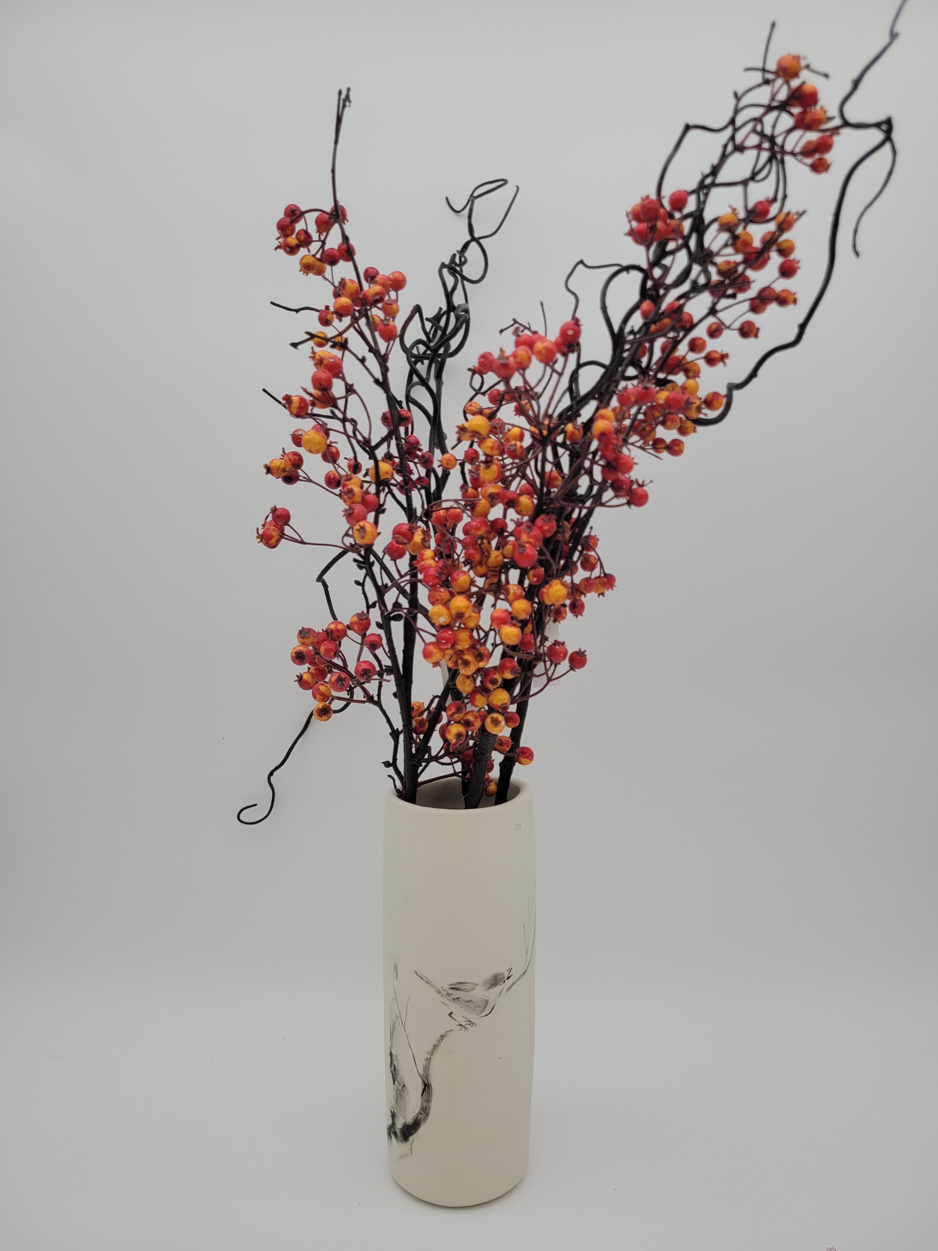White ceramic cylindrical vase with hand painted bird design