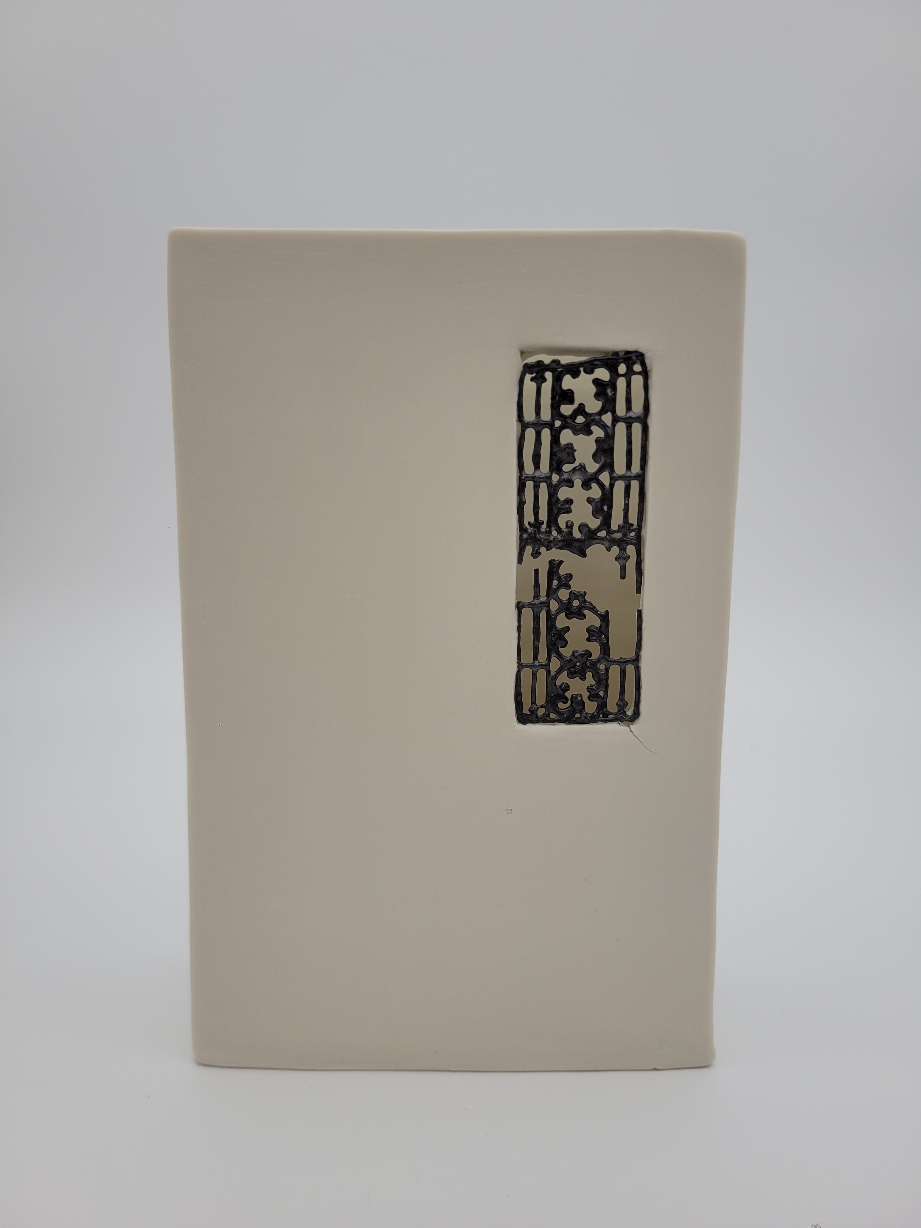 White ceramic rectangular vase with filigree detail