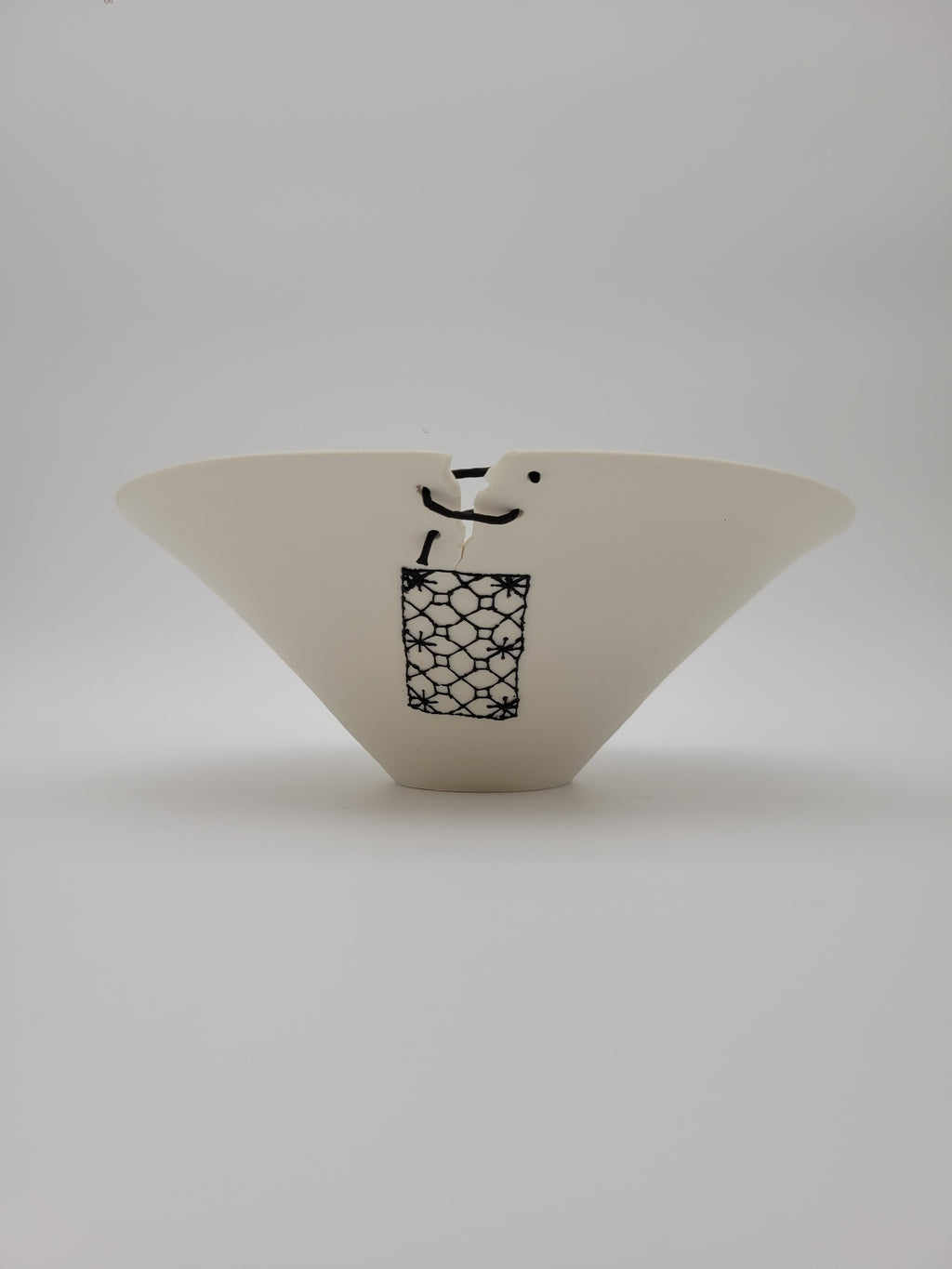 White ceramic bowl, medium size, with filigree detail and decorative opening at rim