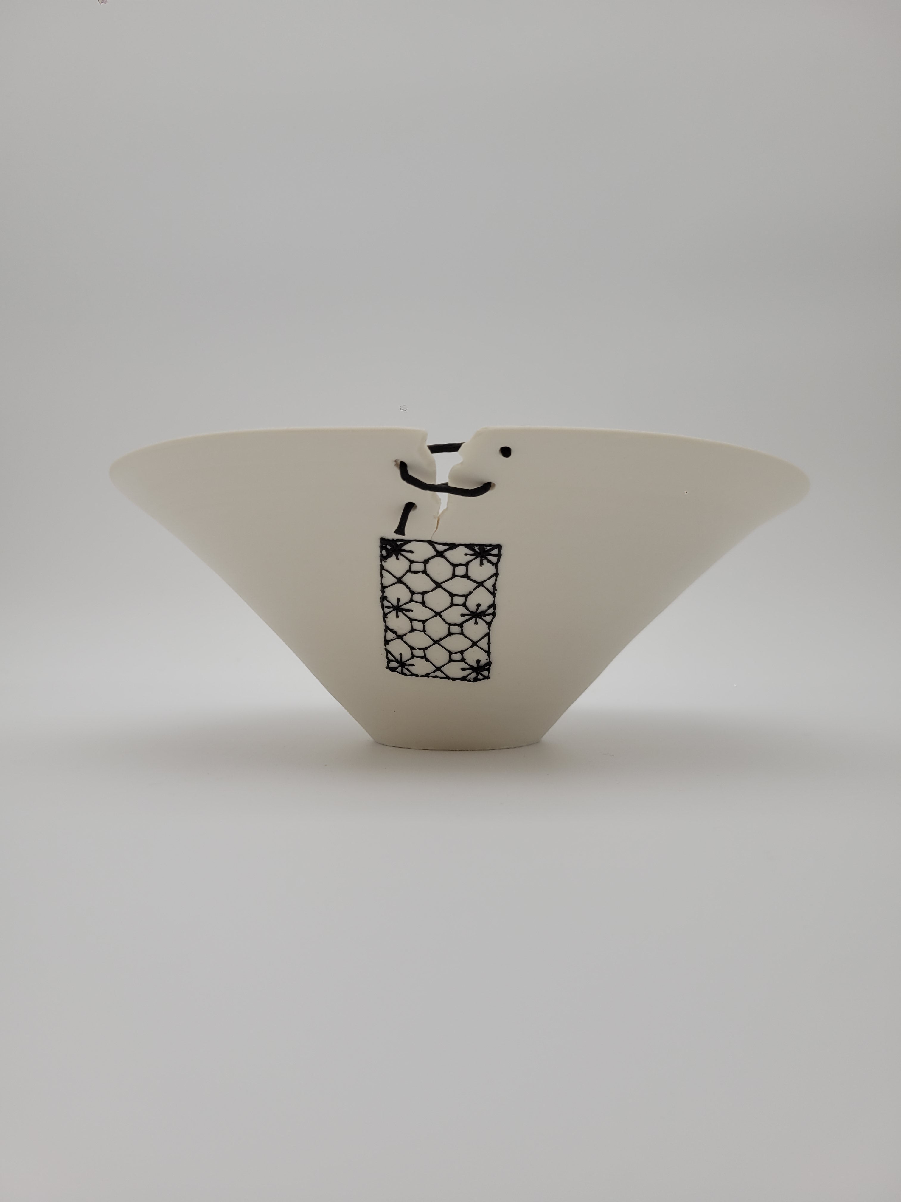 White ceramic bowl, medium size, with filigree detail and decorative opening at rim