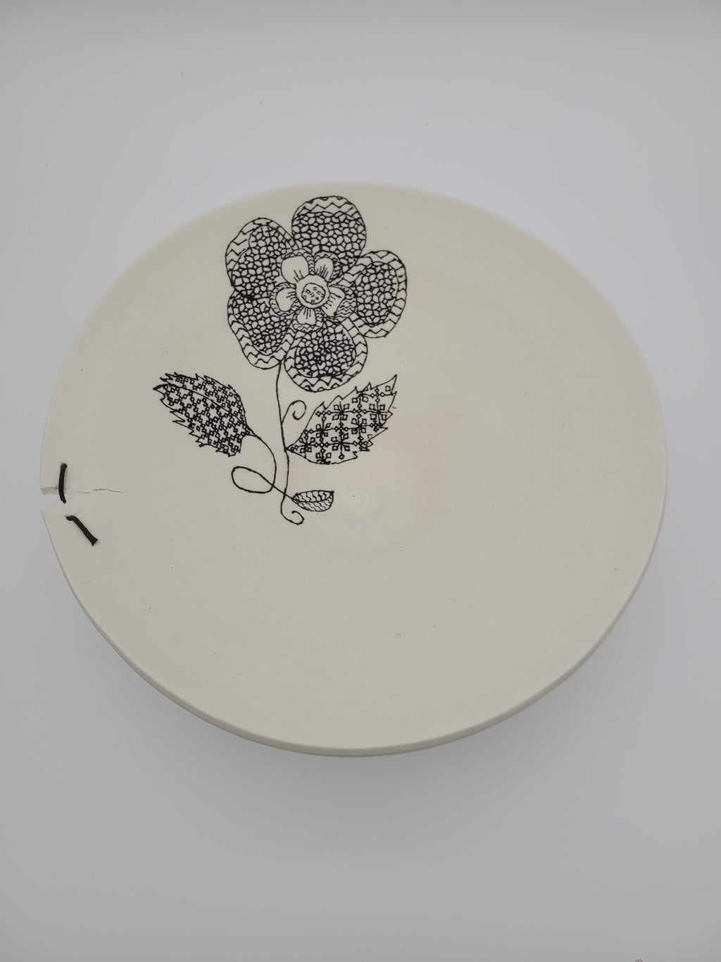 White ceramic bowl with black floral slip work