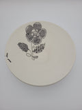 White ceramic bowl with black floral slip work