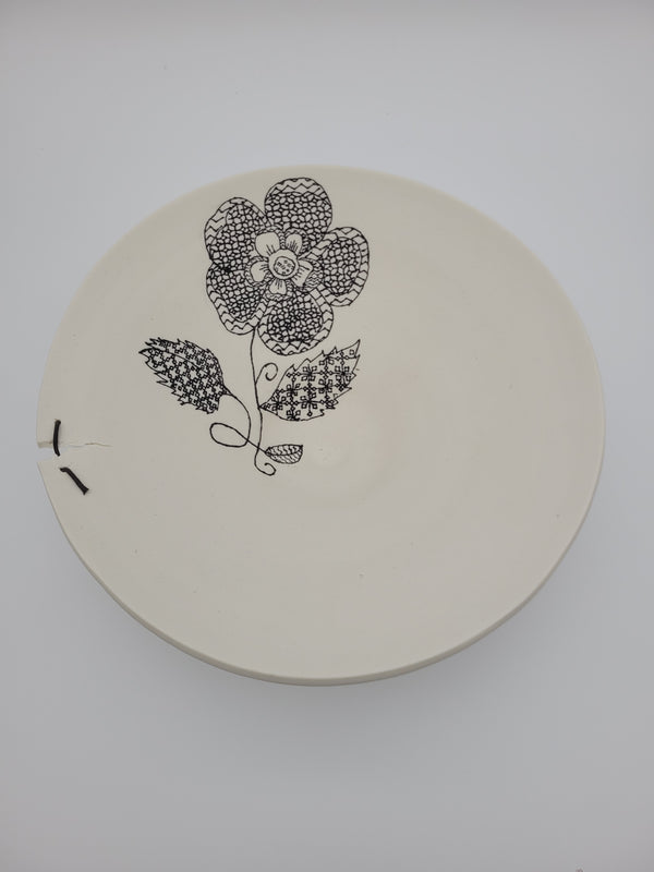 White ceramic bowl with black floral slip work