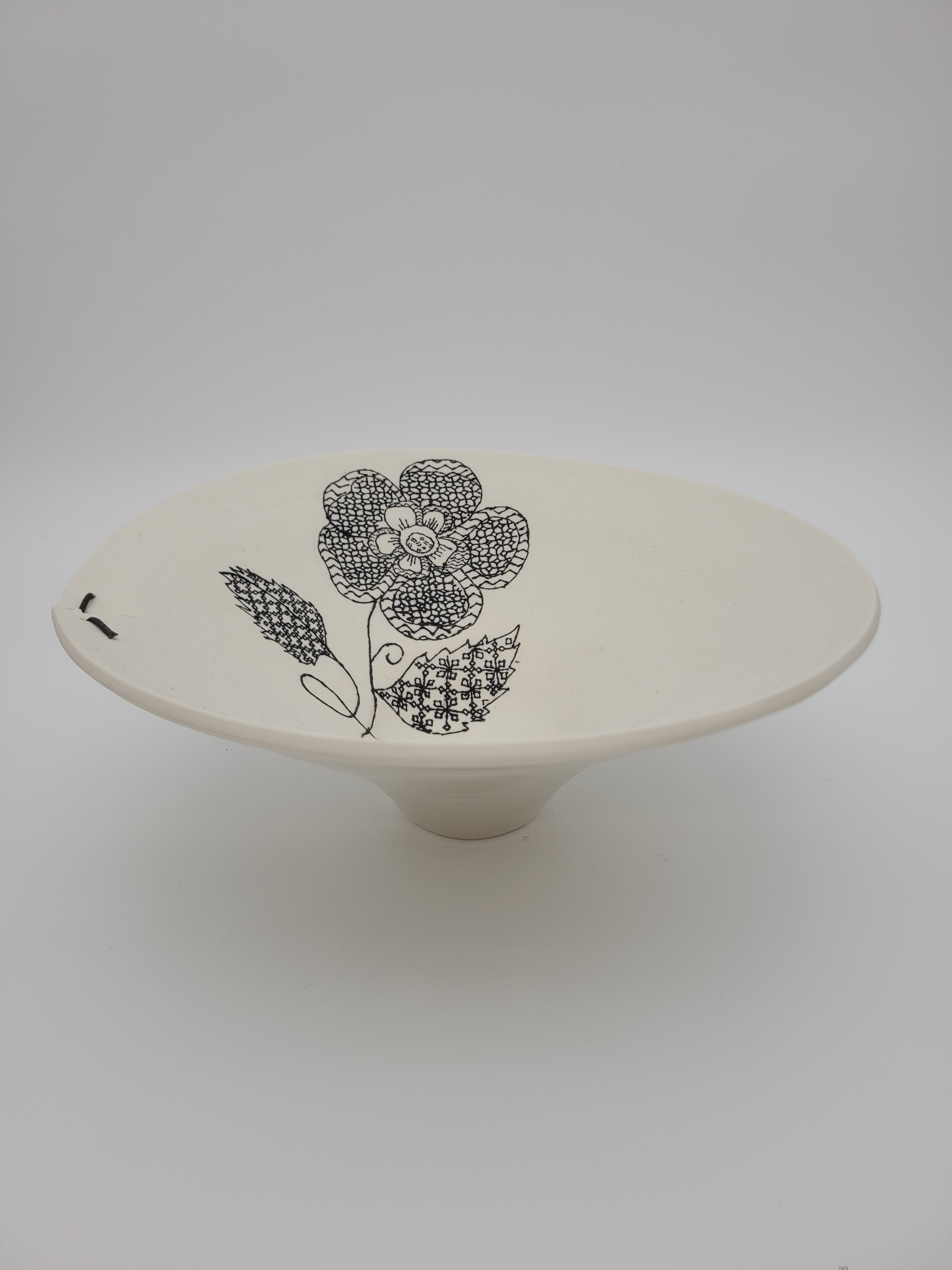 White ceramic bowl with black floral slip work