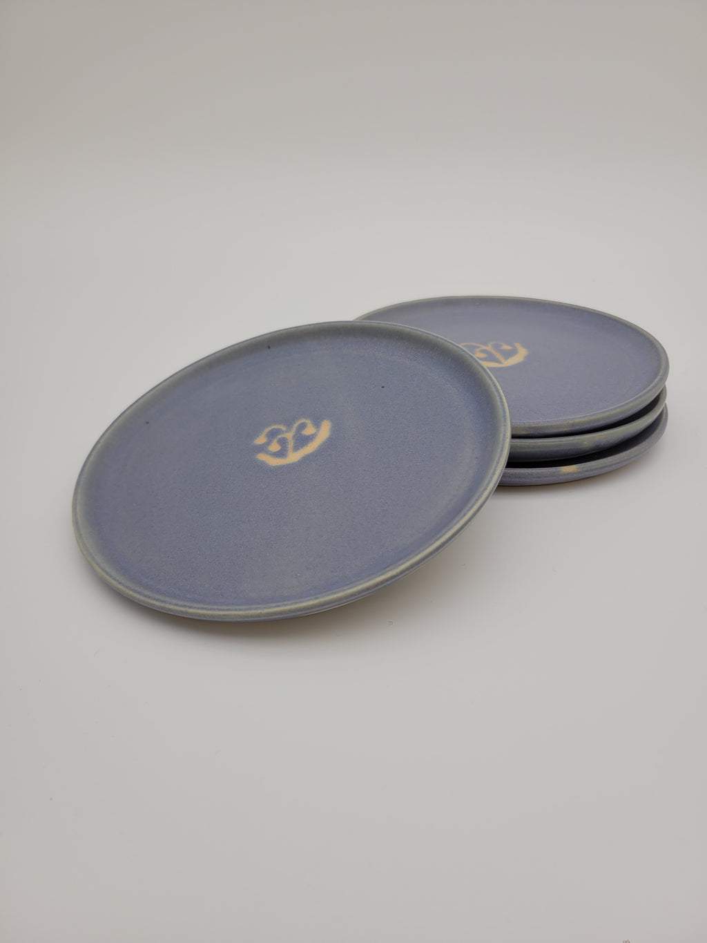 Pale blue small plates with central floral design detail