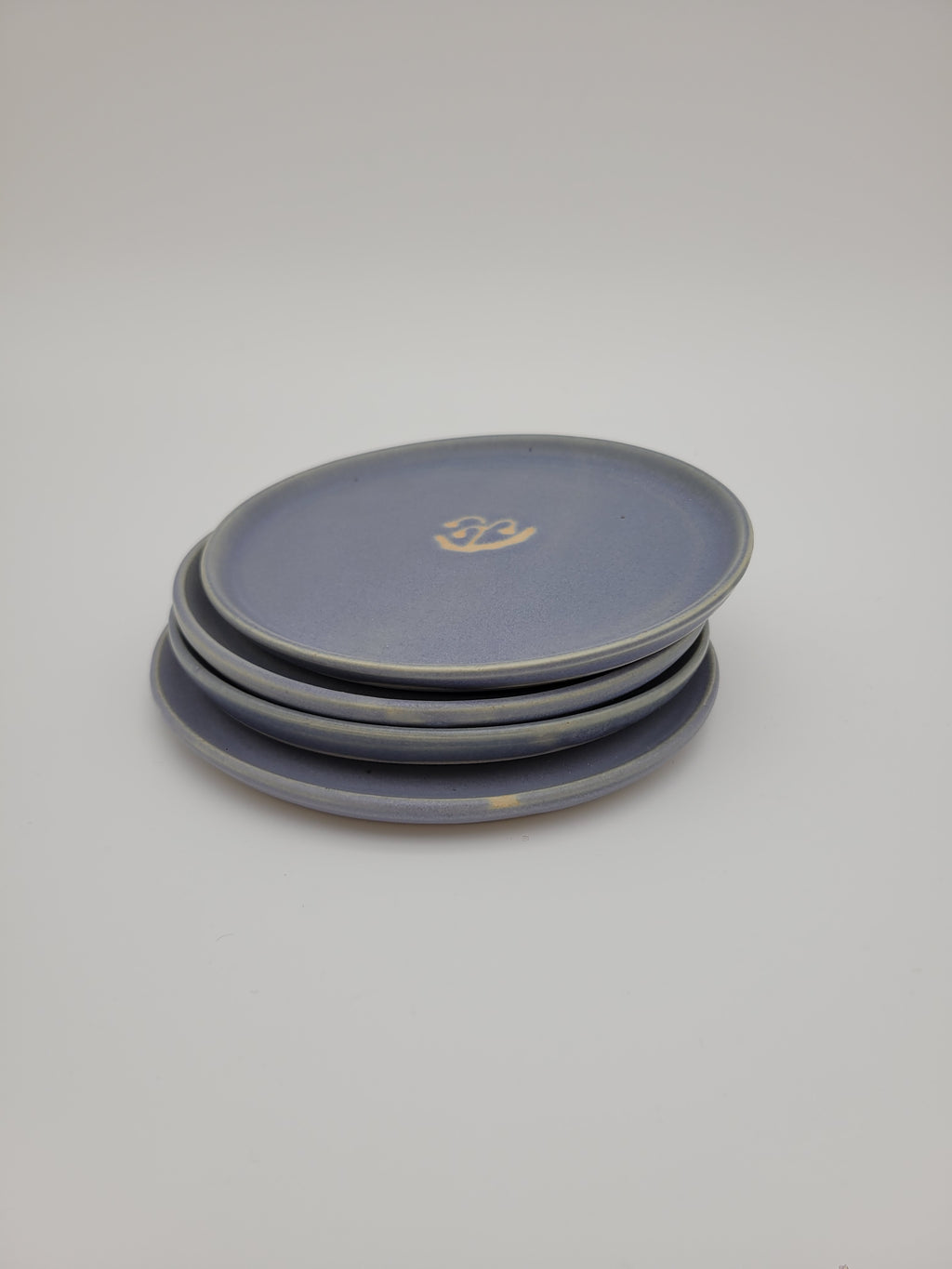 Pale blue small plates with central floral design detail