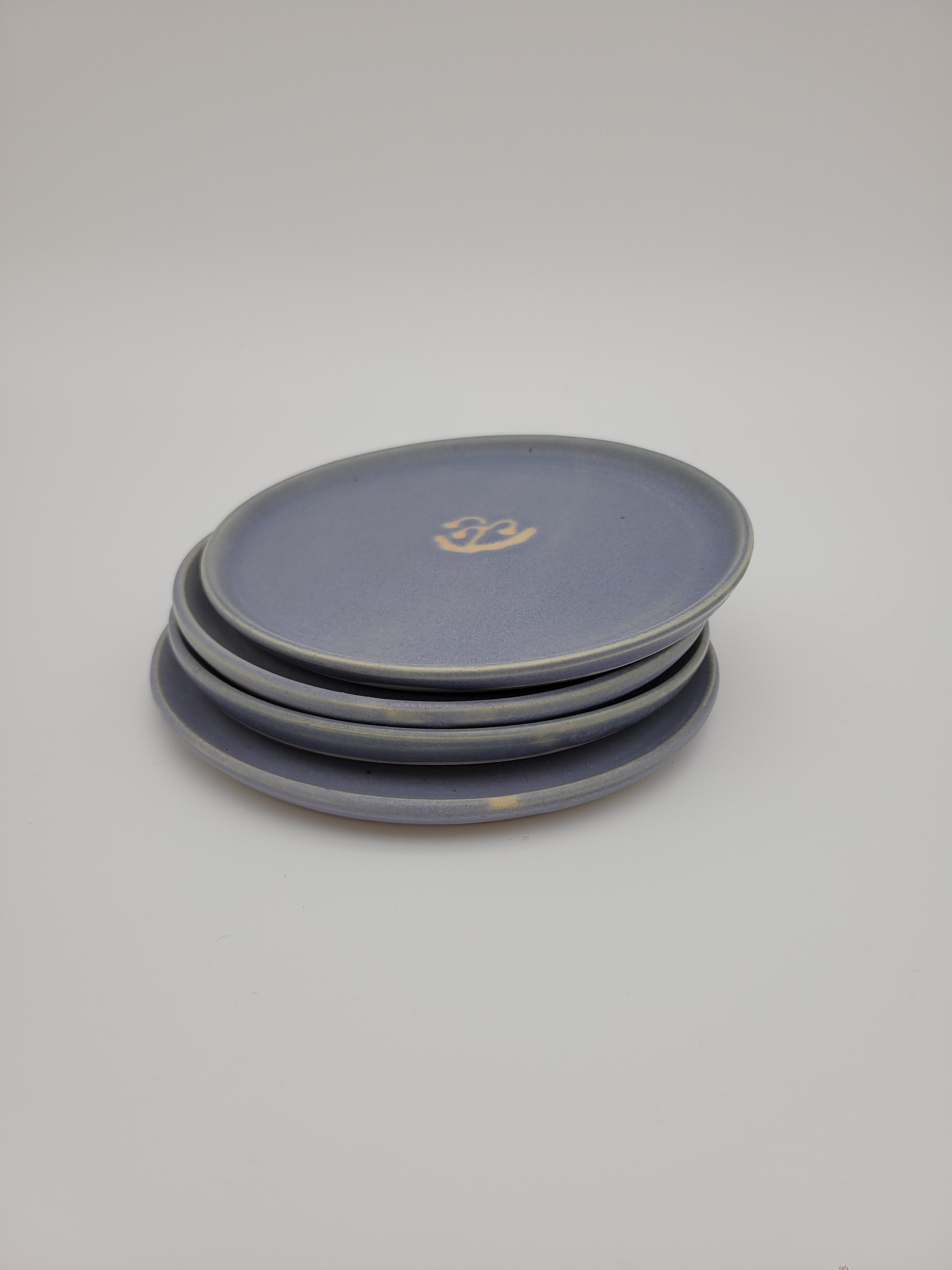 Pale blue small plates with central floral design detail
