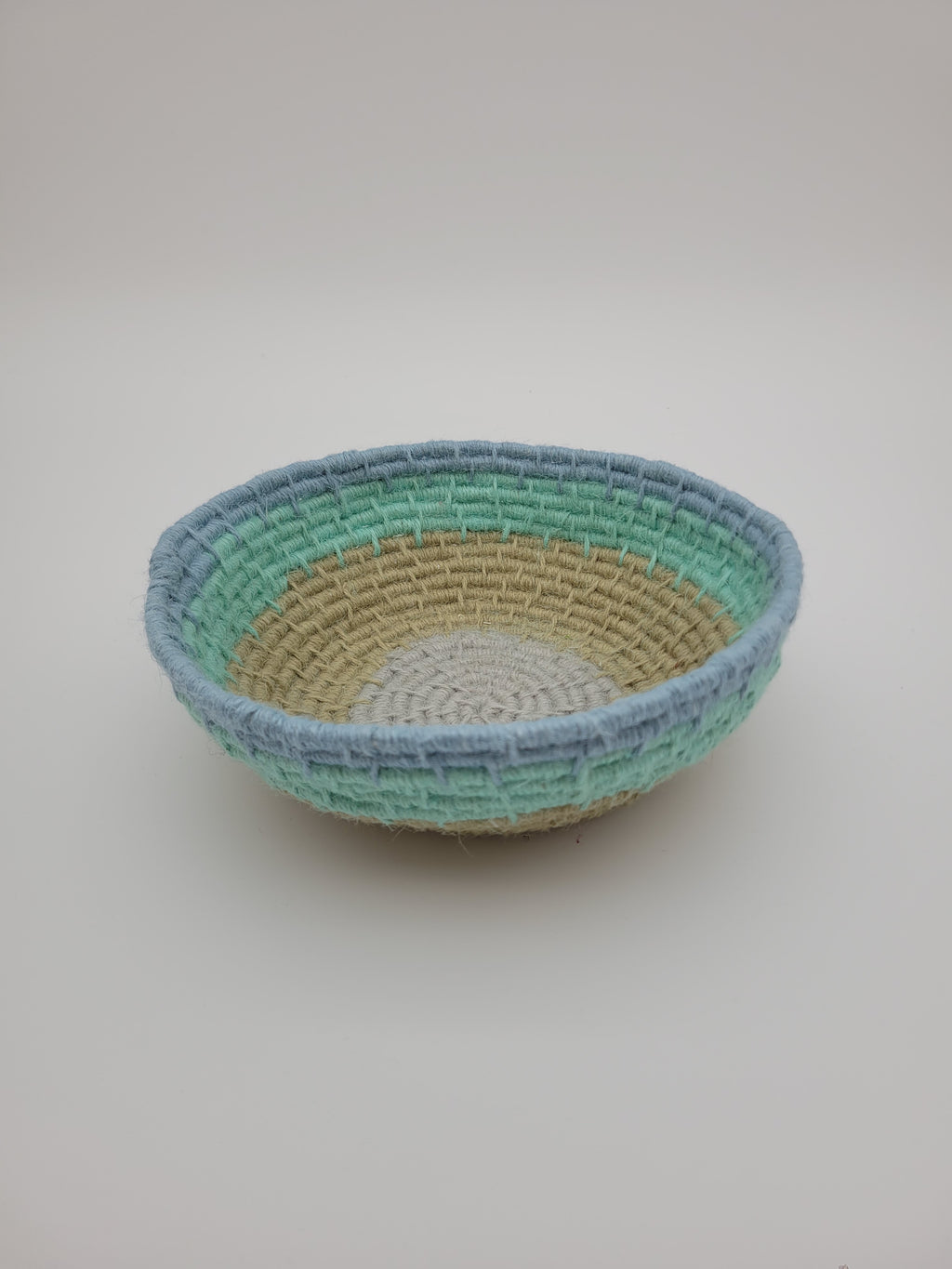 Handmade coiled yarn bowl in natural and sea foam colours