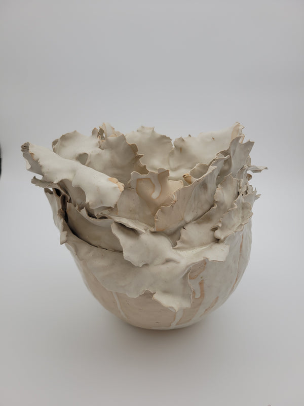 Tall handmade ceramic vase with frilled construction