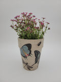 Decoupaged pot with various designs