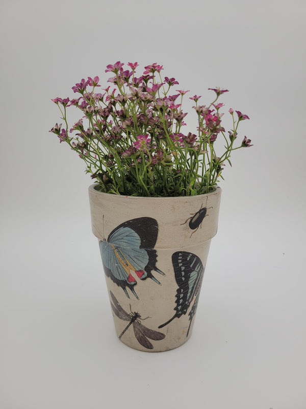 Decoupaged pot with various designs
