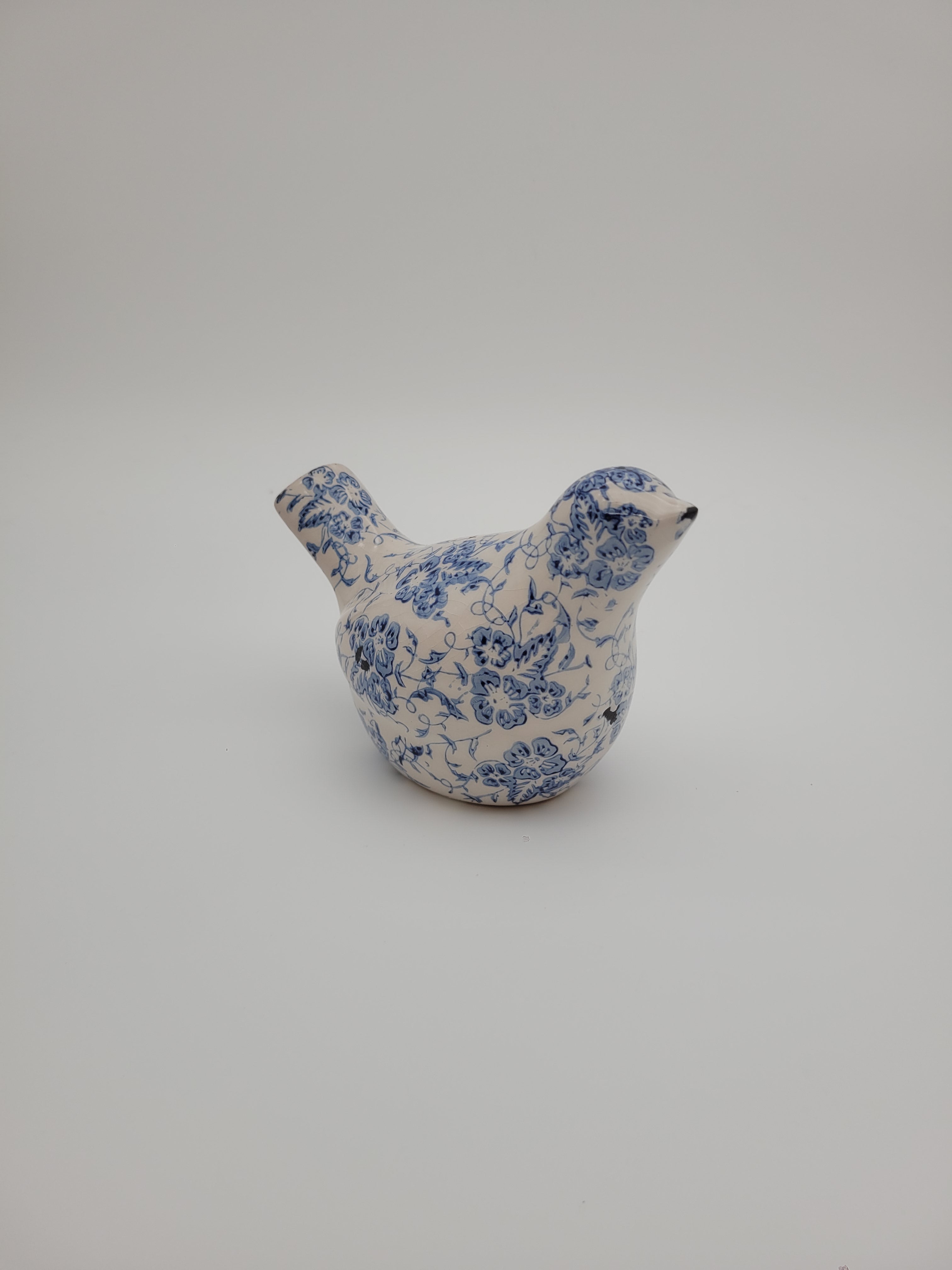 Small decorative bird with blue and white design