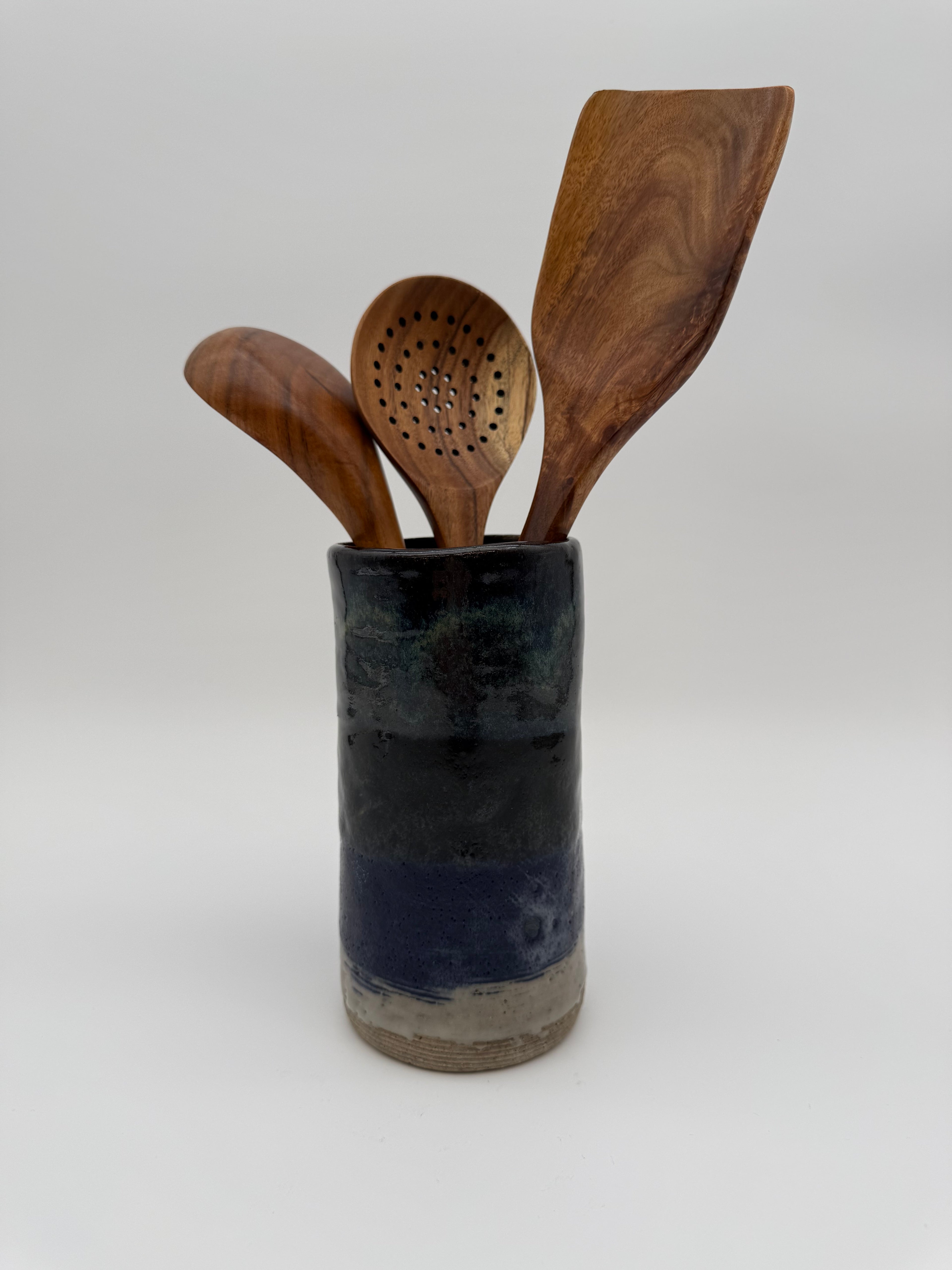 Cylindrical pot with varied tone glaze.
