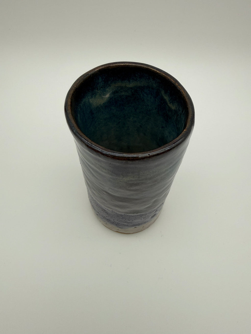 Cylindrical pot with varied tone glaze.