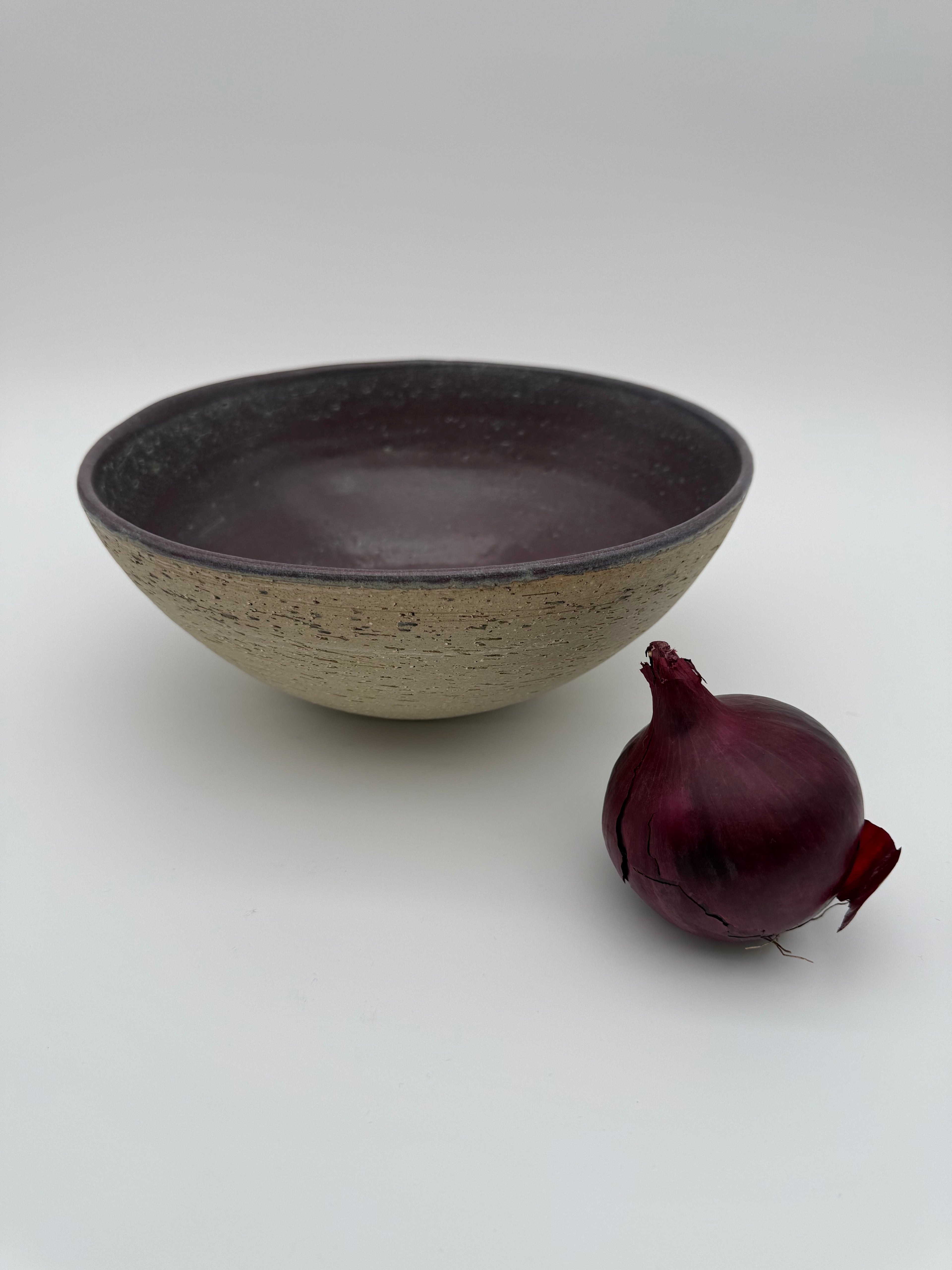 Bowl with aubergine colour interior glaze