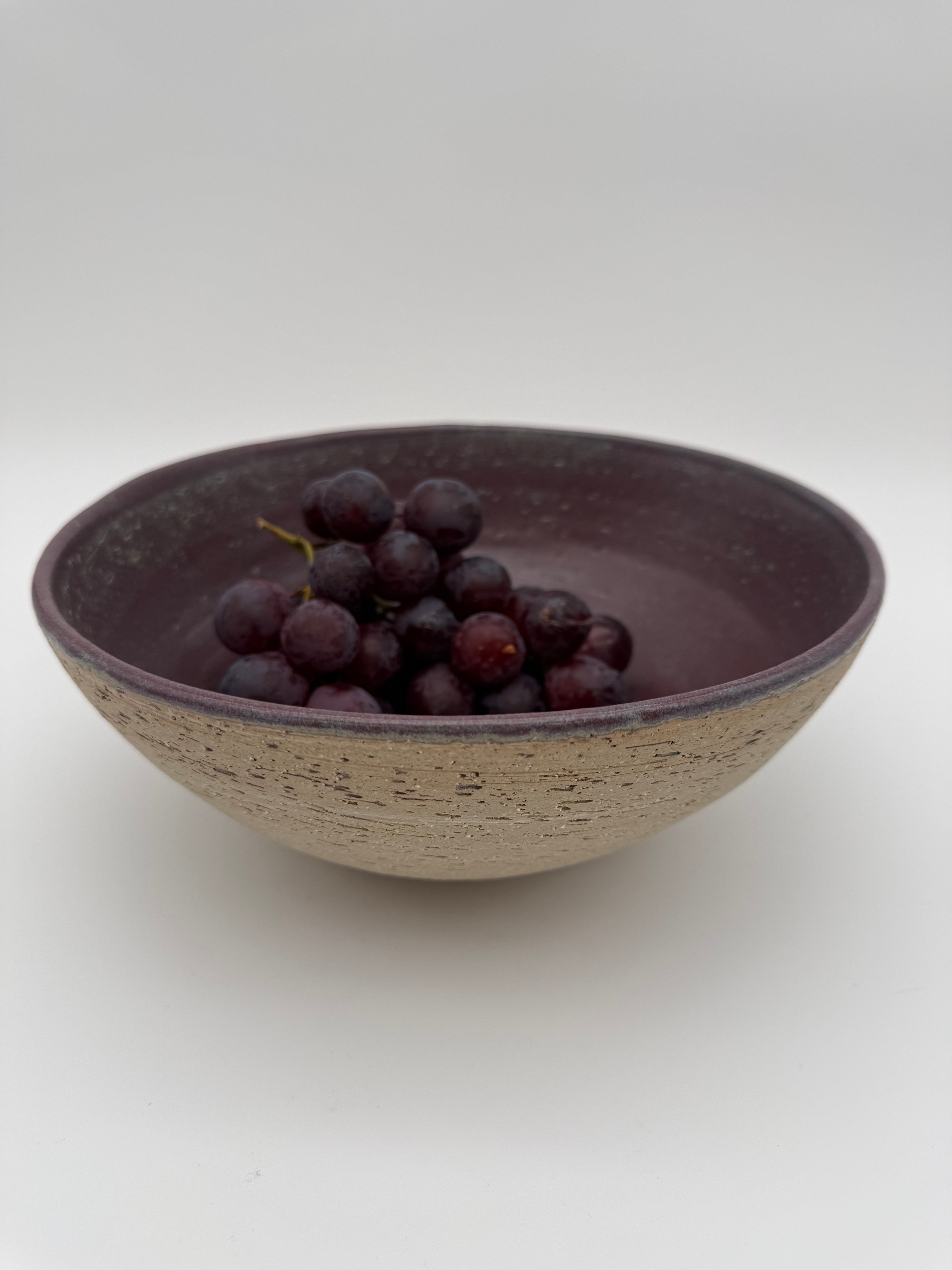 Bowl with aubergine colour interior glaze