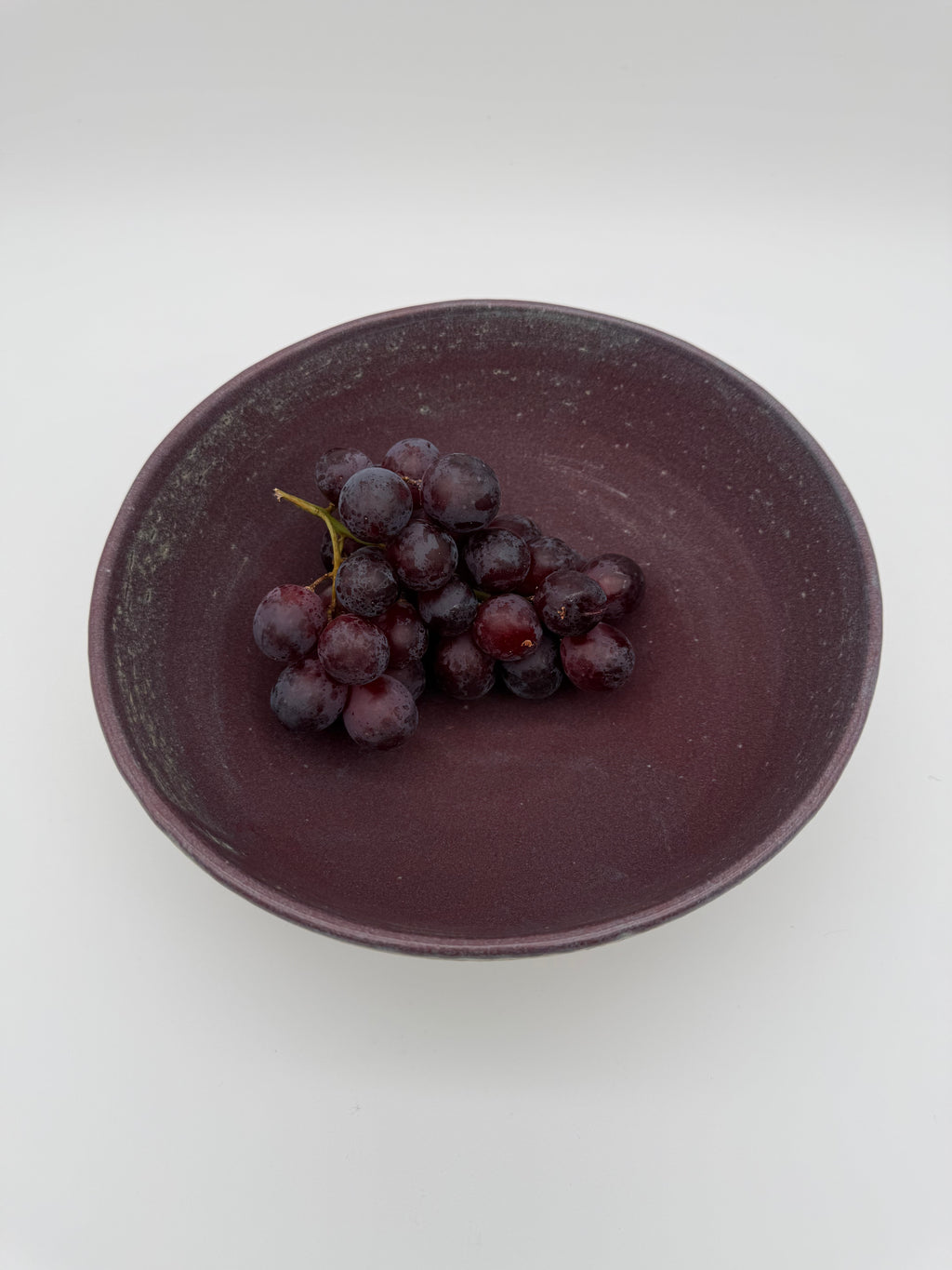 Bowl with aubergine colour interior glaze