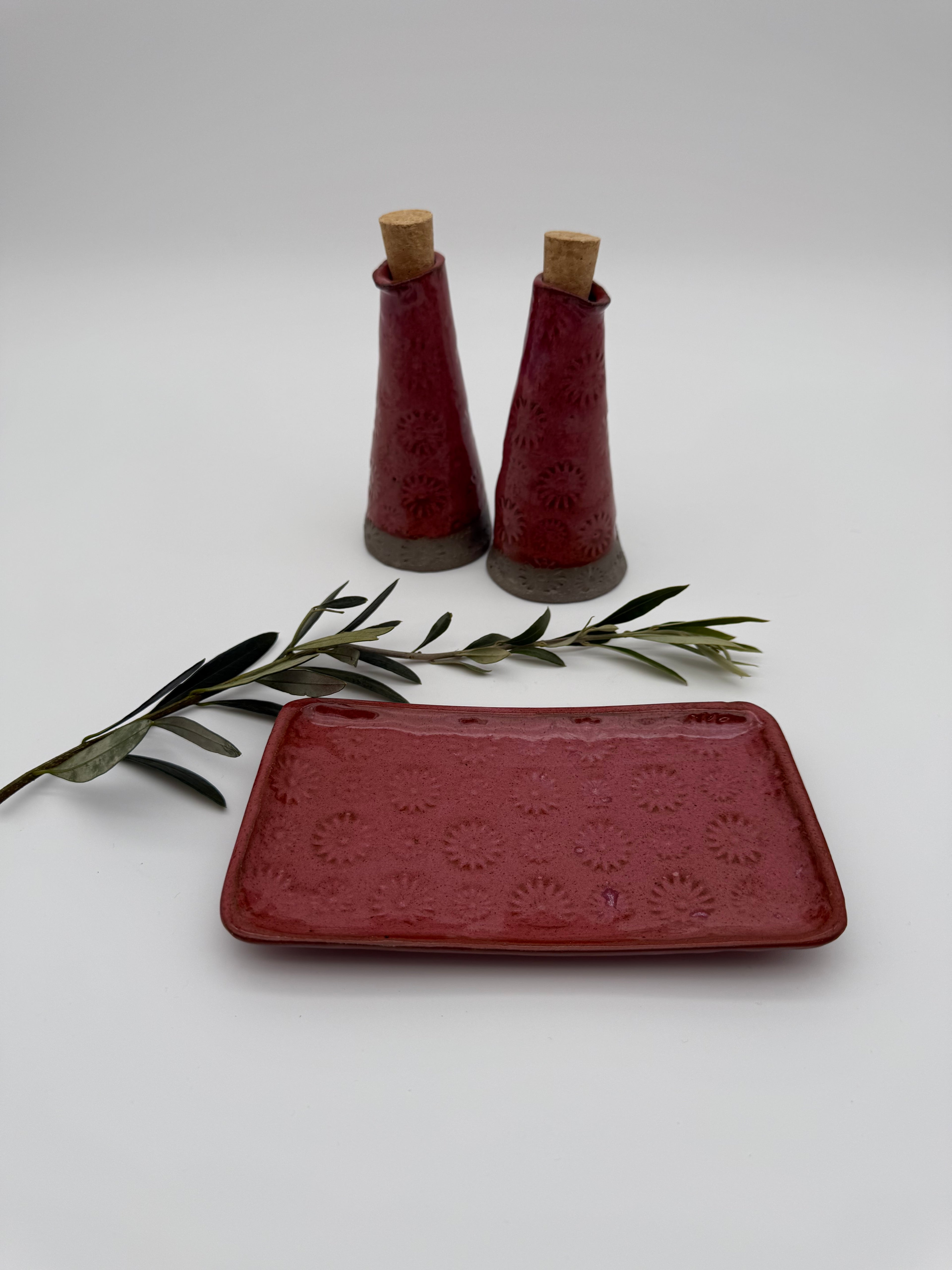 Bottle for oil or vinegar in deep pink glaze with floral design