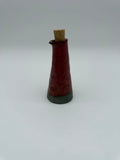 Bottle for oil or vinegar in deep pink glaze with floral design