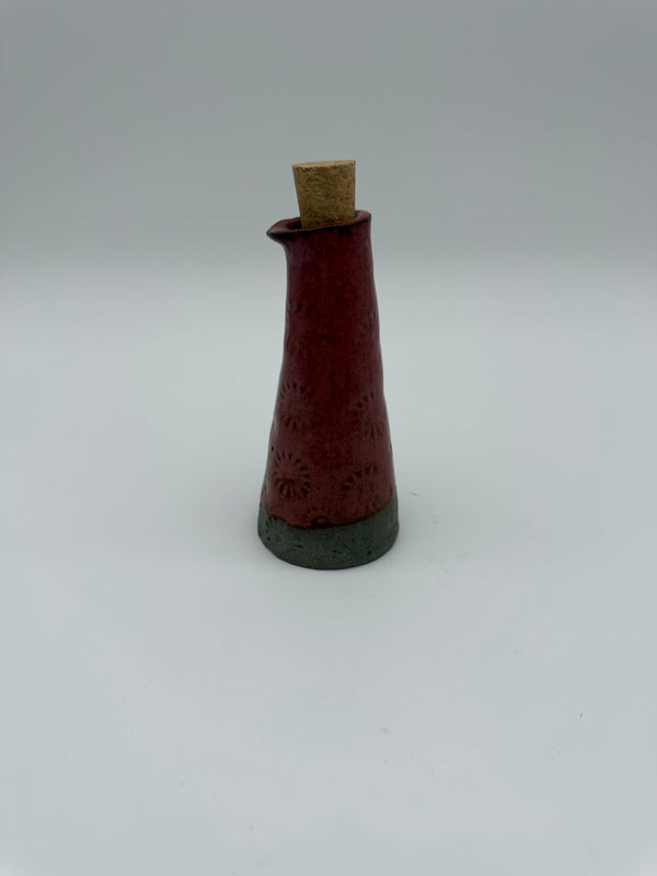 Bottle for oil or vinegar in deep pink glaze with floral design