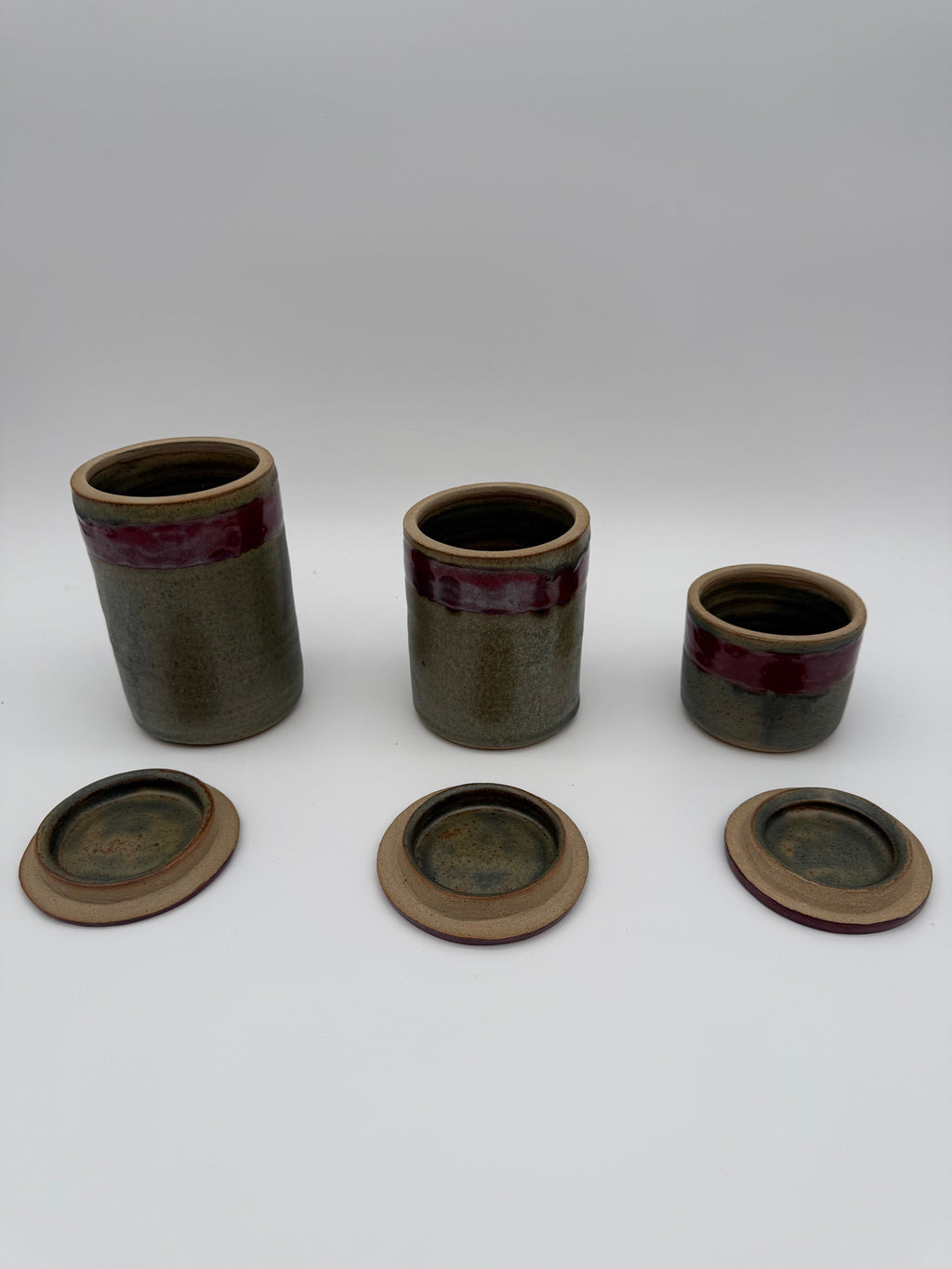Lidded pots with green and brown glaze
