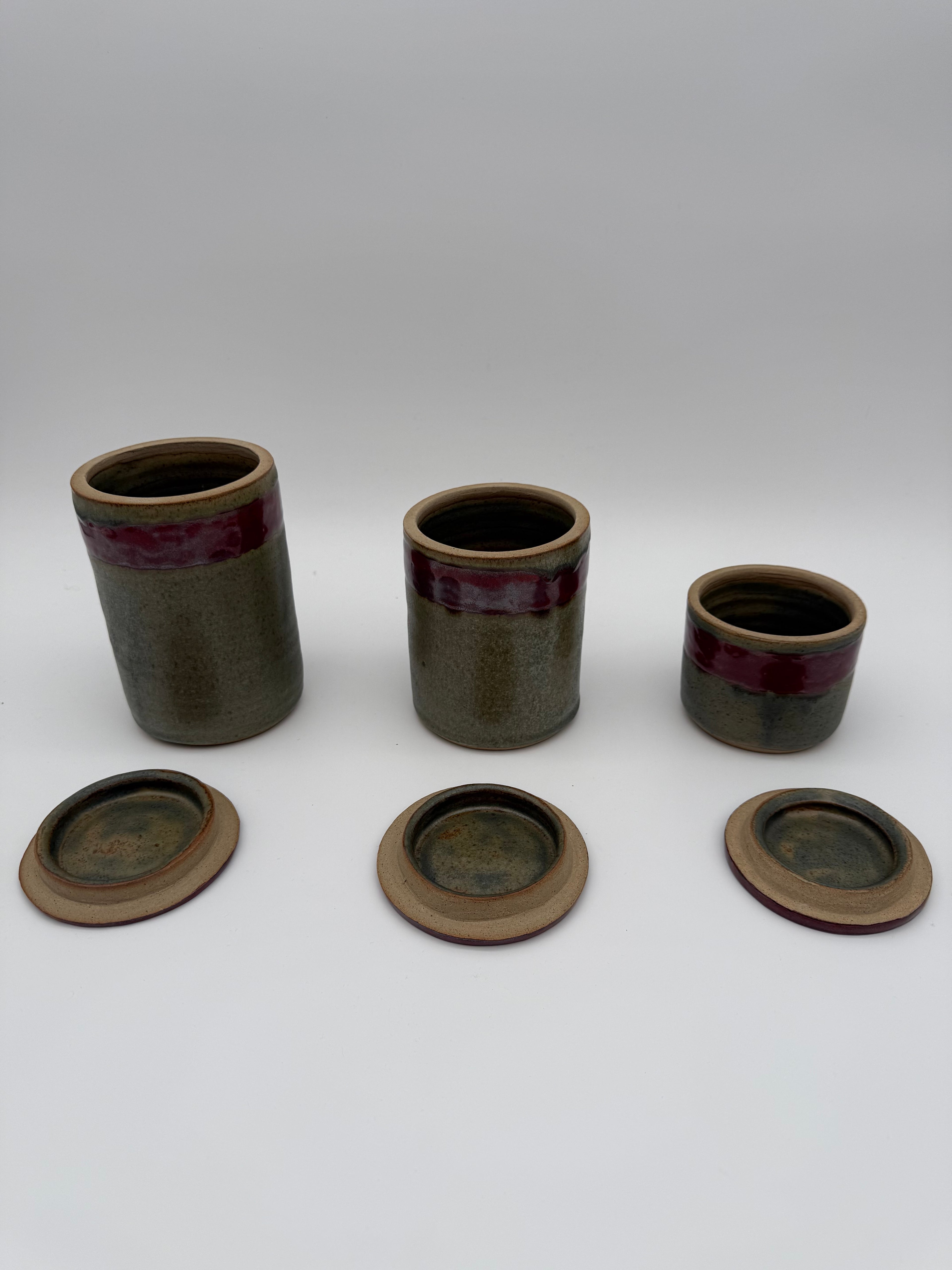 Lidded pots with green and brown glaze