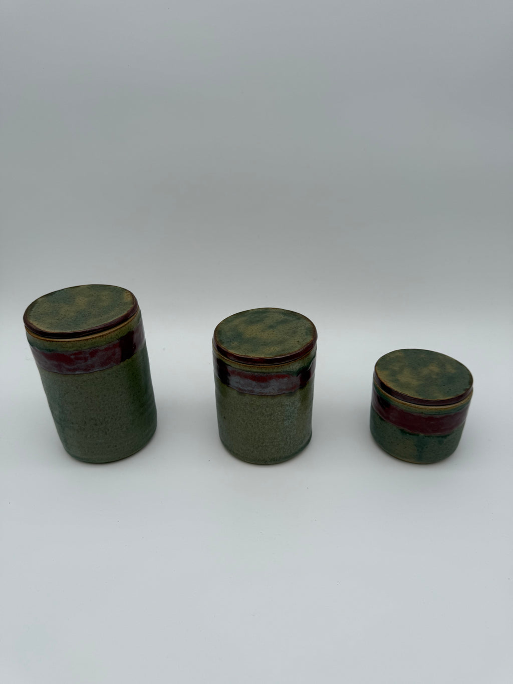 Lidded pots with green and brown glaze