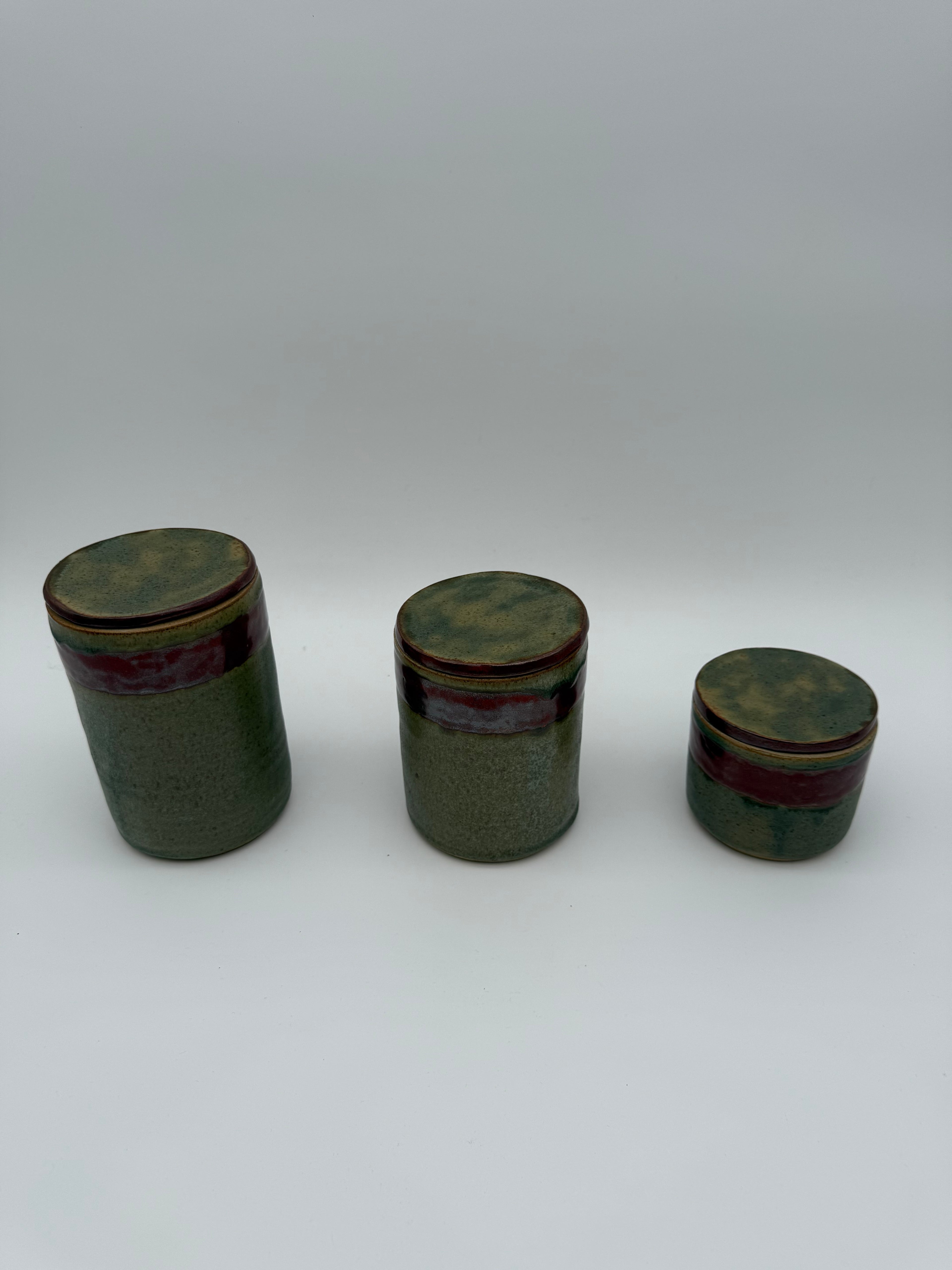 Lidded pots with green and brown glaze