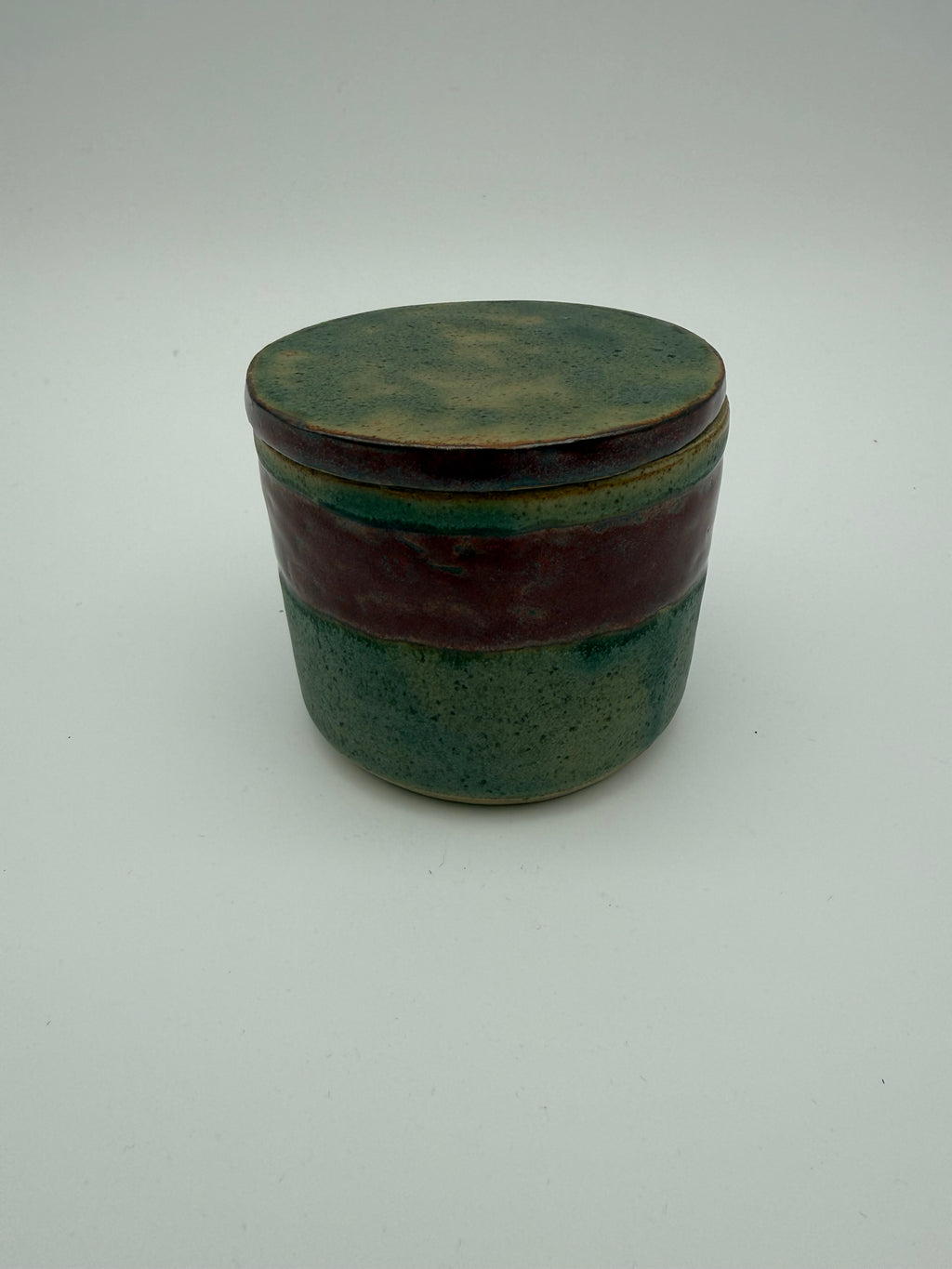 Lidded pots with green and brown glaze