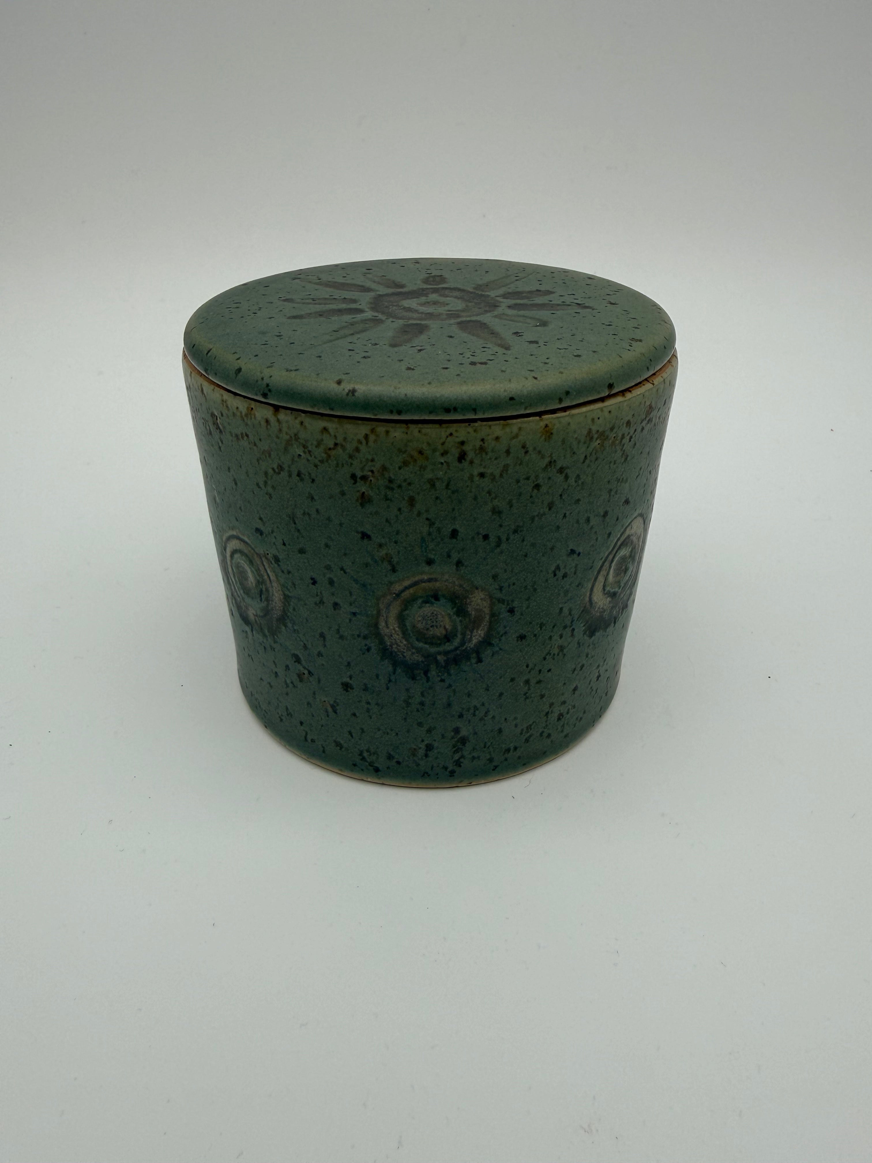 Lidded pots with green and brown glaze