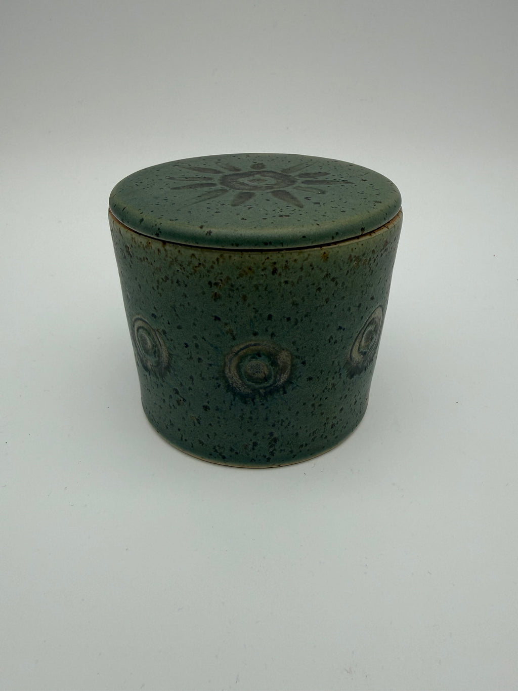 Green glazed butter crock with circular / sunburst decorative detail