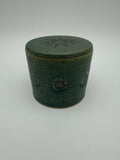 Green glazed butter crock with circular / sunburst decorative detail