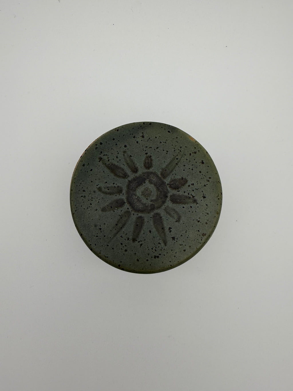 Green glazed butter crock with circular / sunburst decorative detail