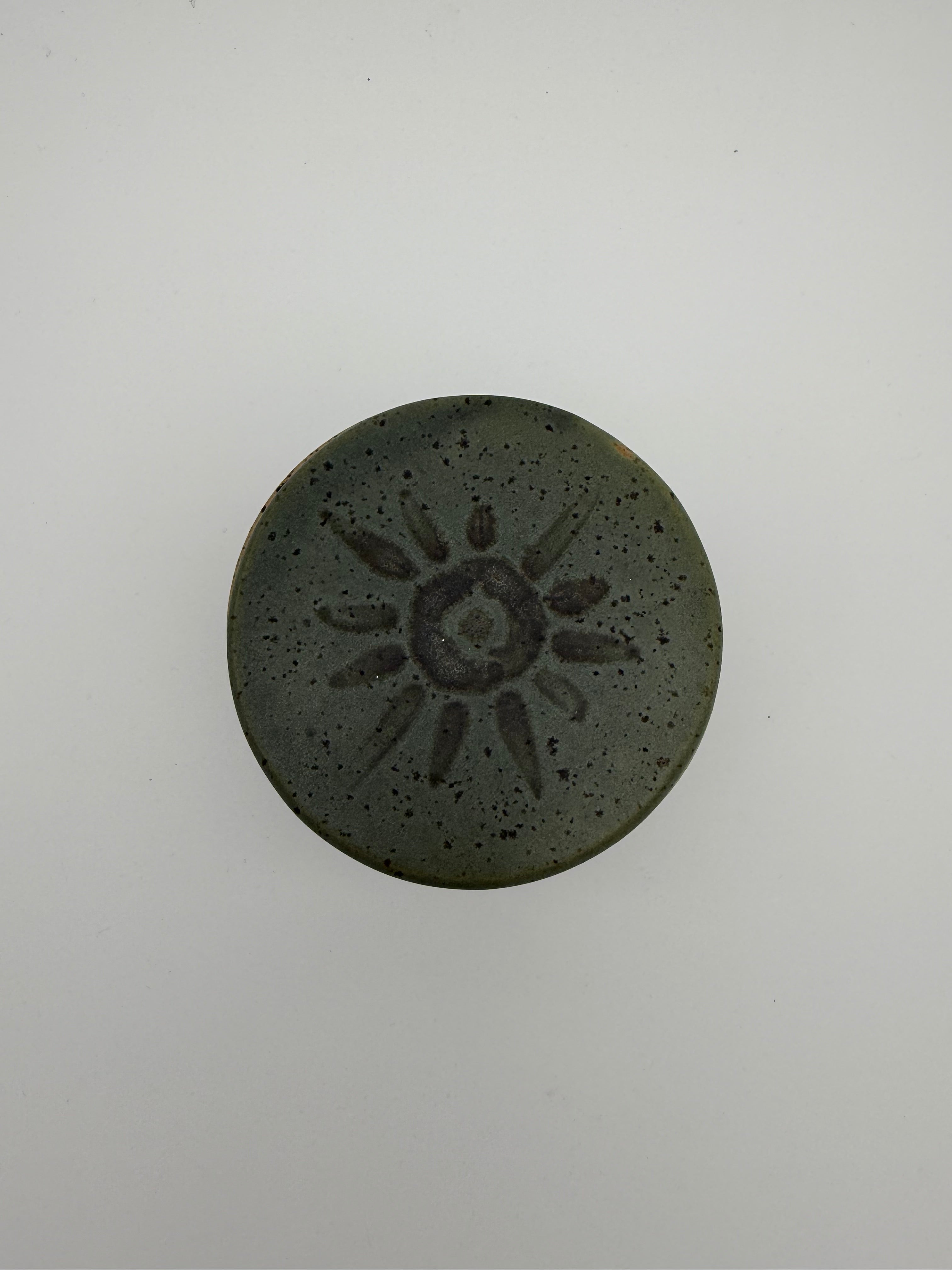 Green glazed butter crock with circular / sunburst decorative detail