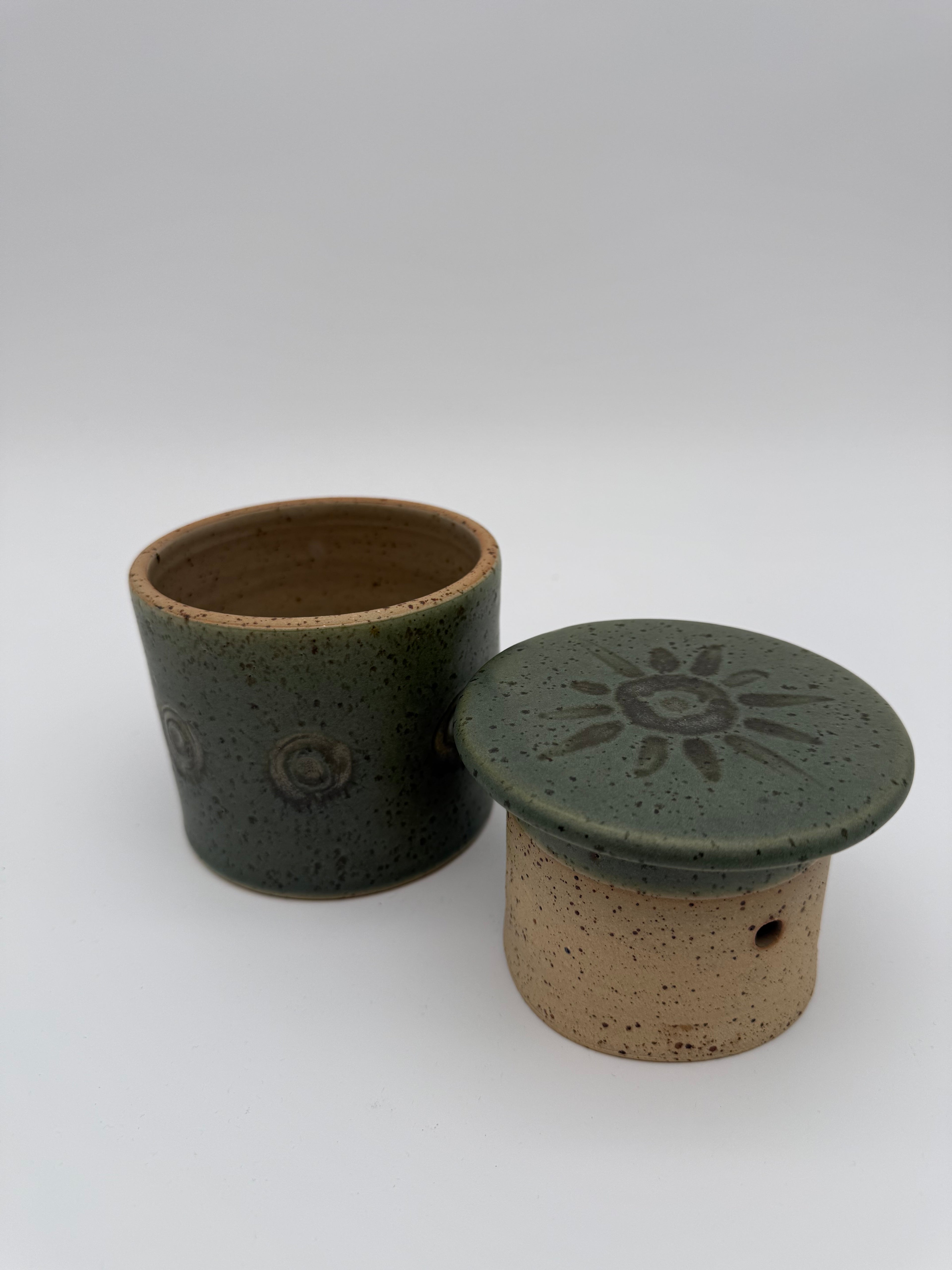 Green glazed butter crock with circular / sunburst decorative detail