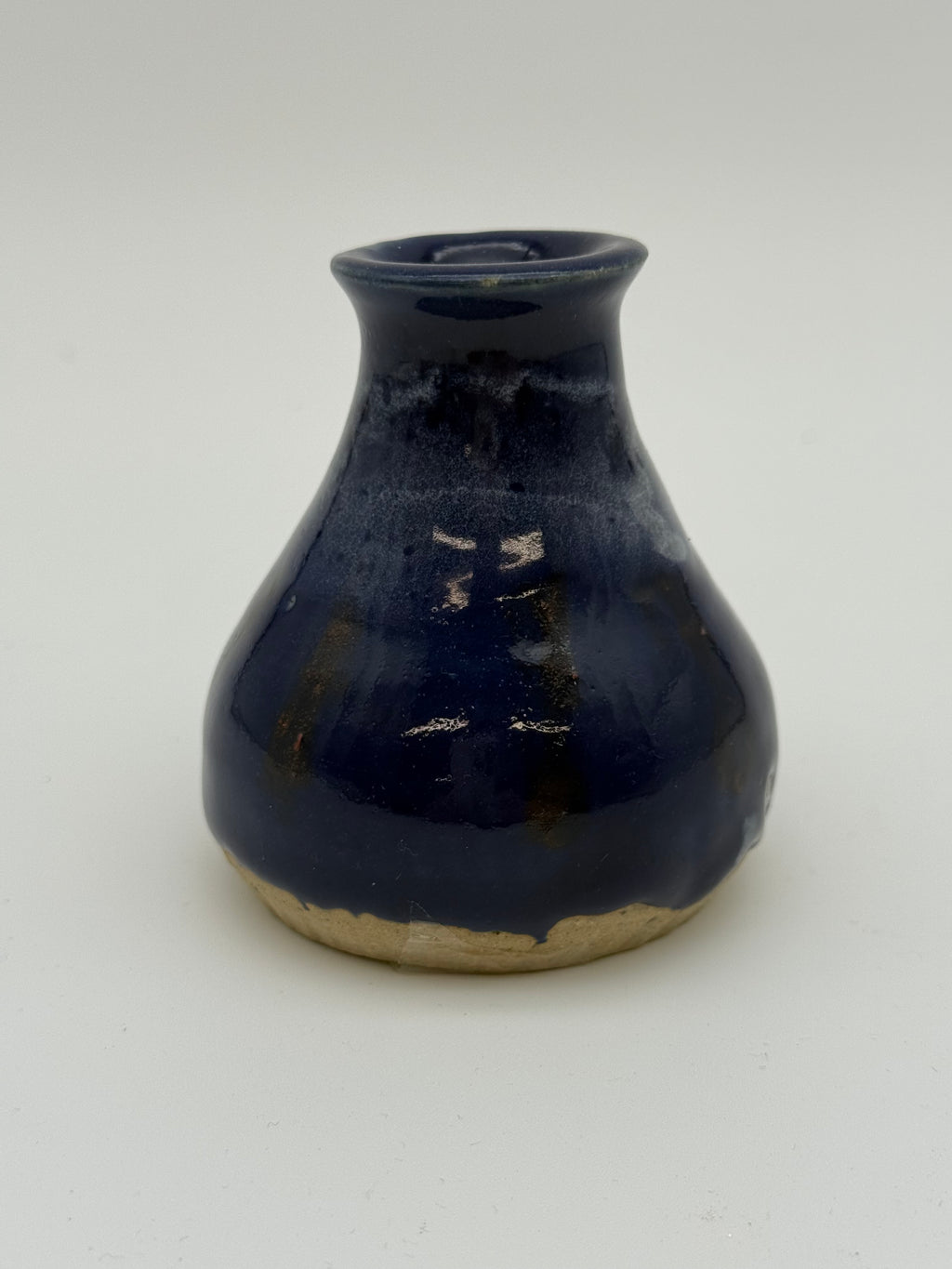 Blue glazed bud vase with white detail at collar
